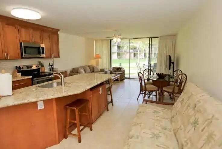 Furnished primary bedroom with window air conditioning at Maui Sunset A103 in Kihei