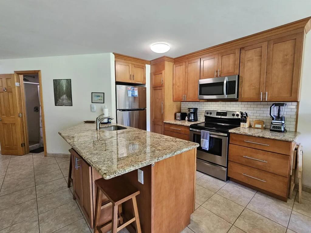 Fully equipped kitchen with granite countertops and updated cabinetry at Maui Sunset A103