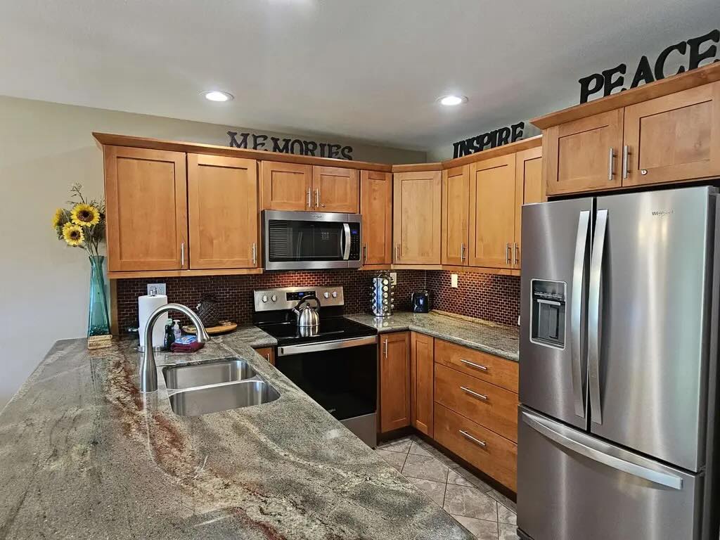 Granite countertop kitchen and updated cabinetry at Maui Kamaole F-102