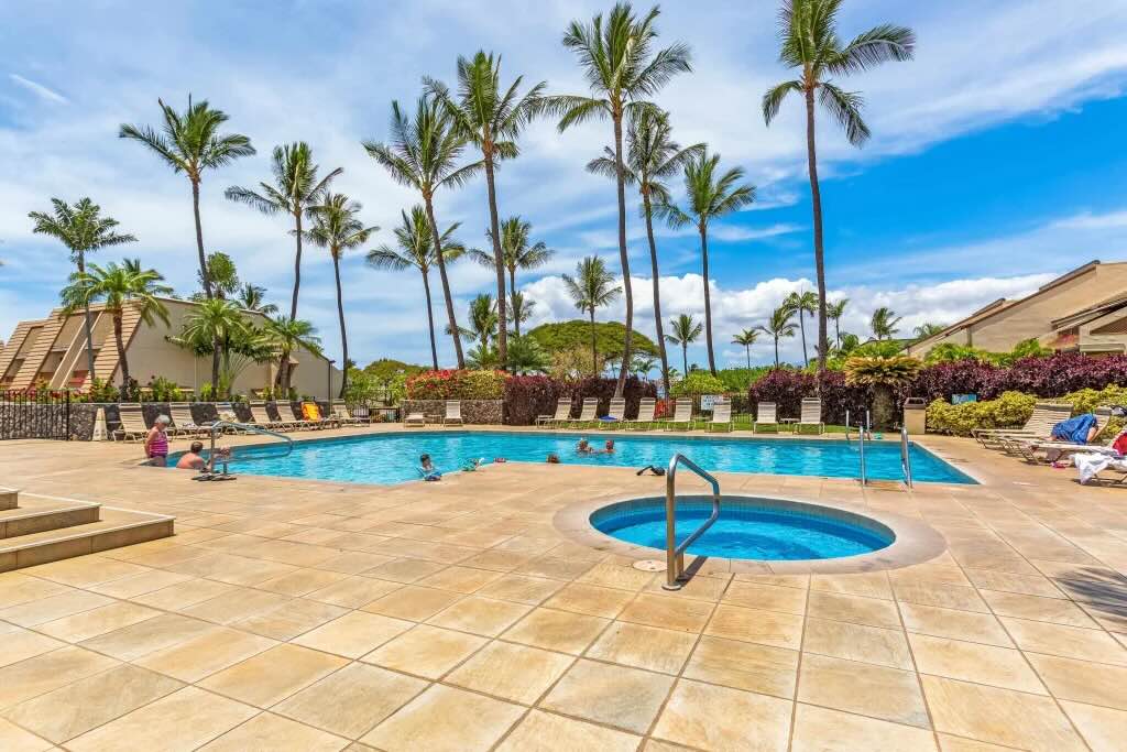 Heated tropical pool and landscaped resort grounds near Maui Kamaole Unit L204 in Kihei