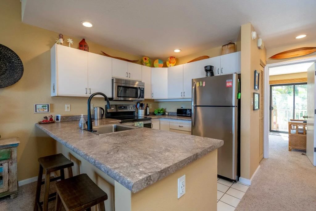 Kitchen inside 2777 S Kihei Rd L204 with stainless steel appliances and furnished dining space