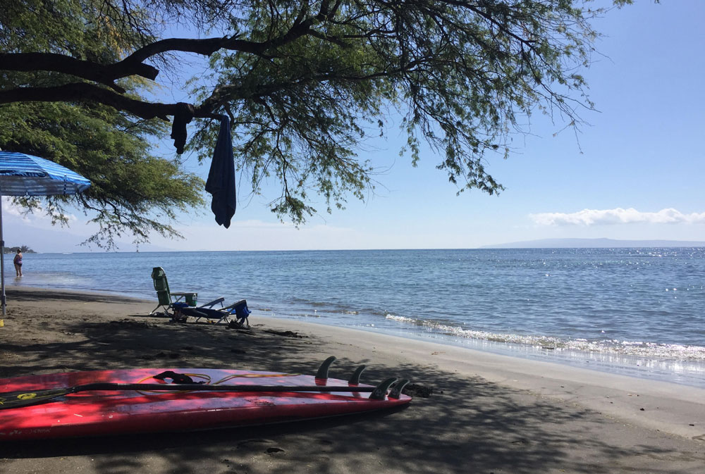 Olowalu Beach on a sunny afternoon with calm water and West Maui shoreline views